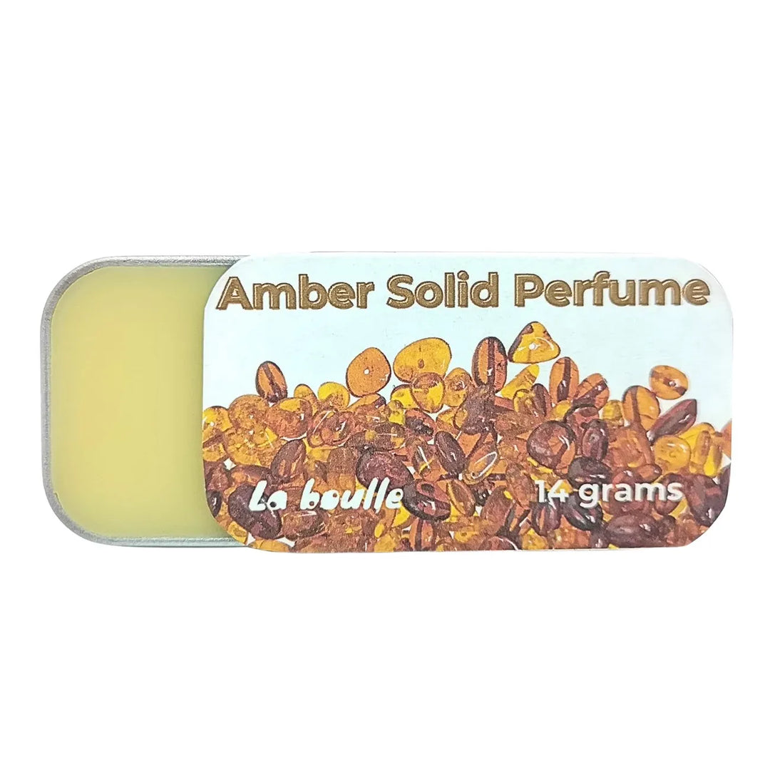 Amber solid natural perfume balm, La Boulle, on a white background