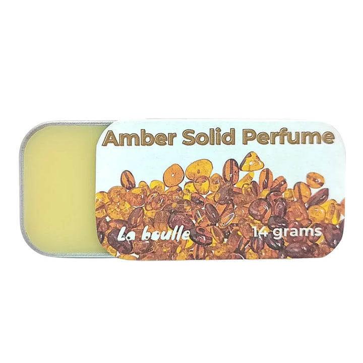 Amber solid natural perfume balm, La Boulle, on a white background