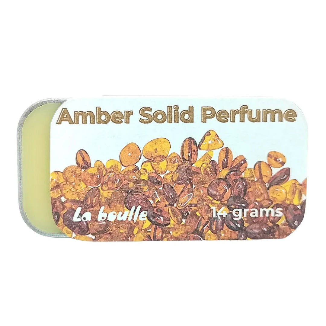 Amber solid natural perfume balm, La Boulle, on a white background