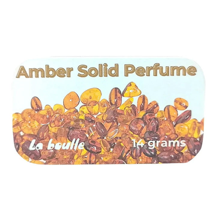Amber solid natural perfume balm, La Boulle, on a white background