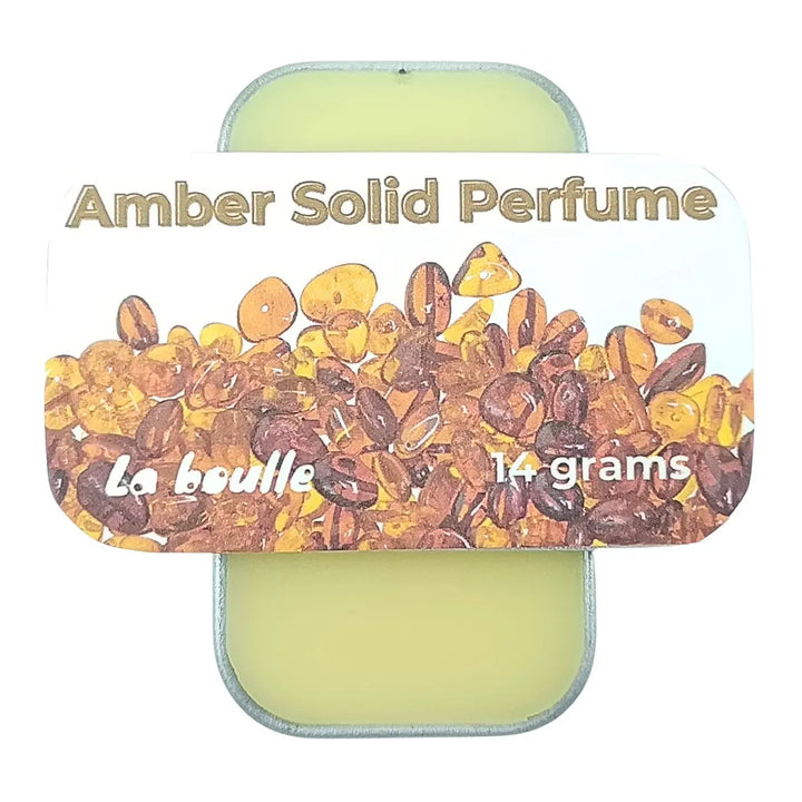 Amber solid natural perfume balm, La Boulle, on a white background