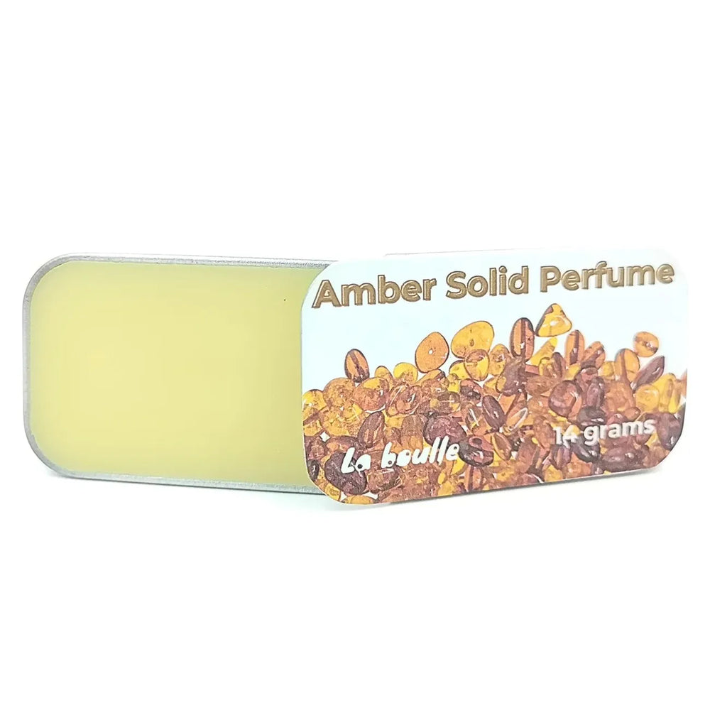 Amber solid natural perfume balm, La Boulle, on a white background
