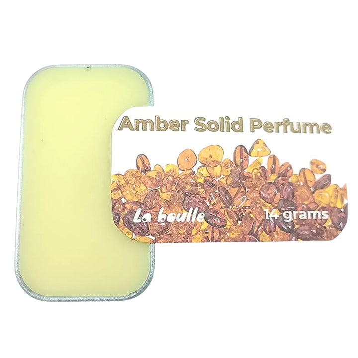 Amber solid natural perfume balm, La Boulle, on a white background
