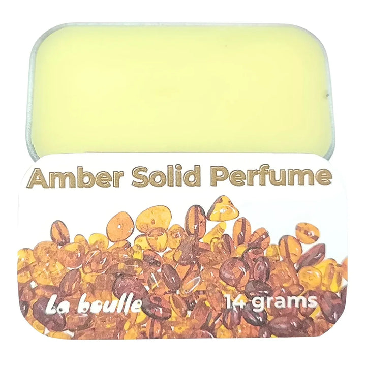 Amber solid natural perfume balm, La Boulle, on a white background