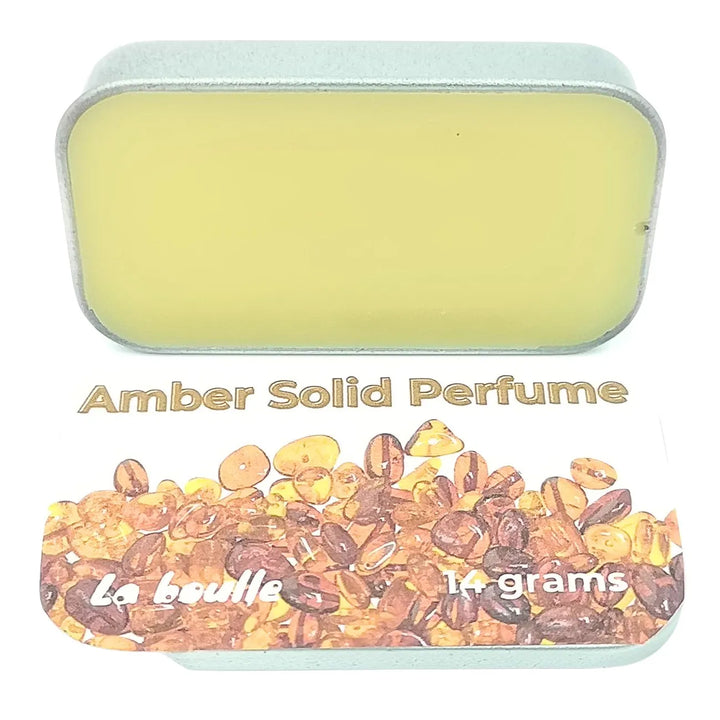 Amber solid natural perfume balm, La Boulle, on a white background