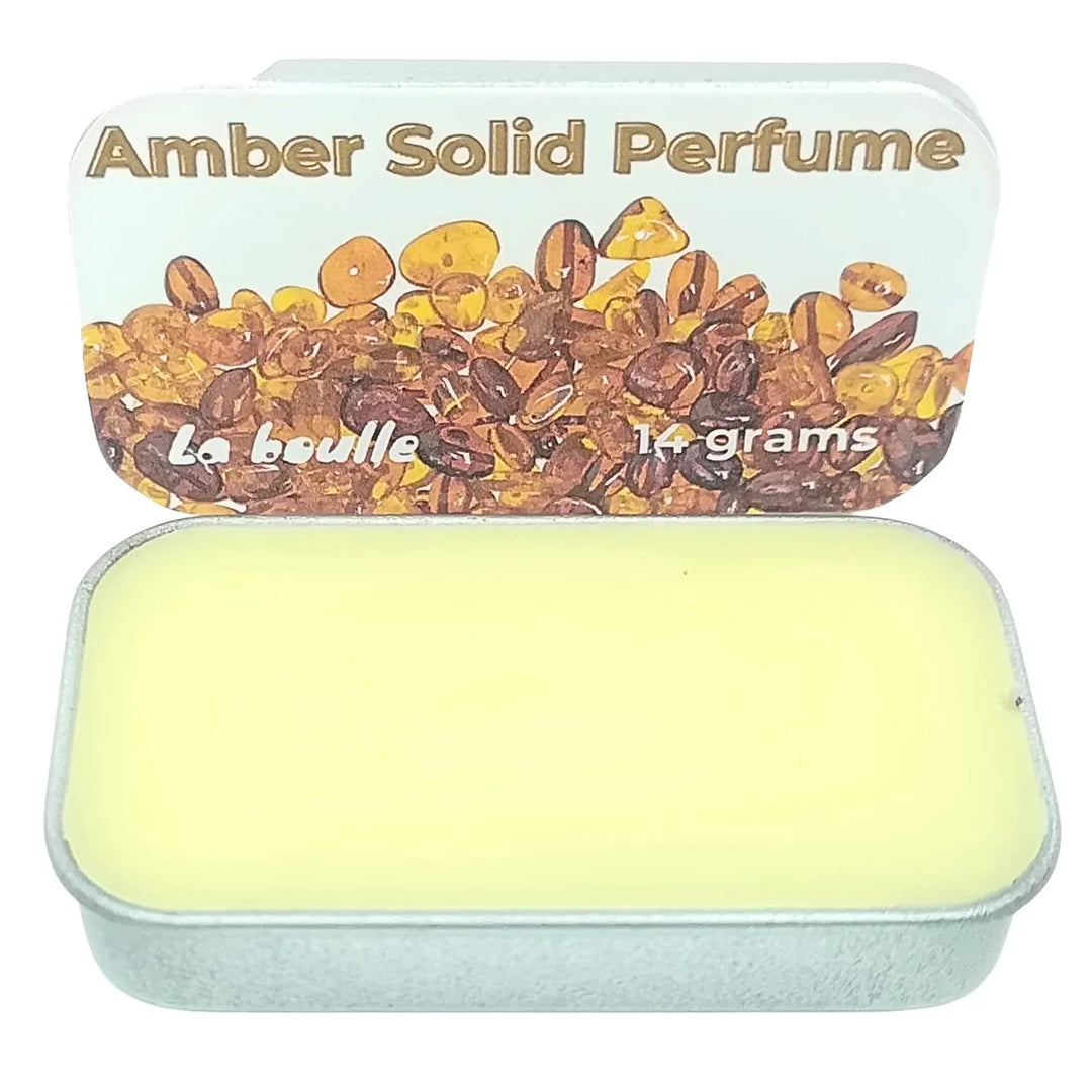 Amber solid natural perfume balm, La Boulle, on a white background