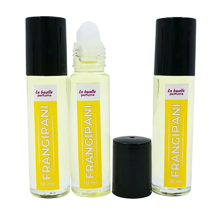 Set of three Frangipani perfume roll-on bottles La Boulle with yellow labels and black caps on a white background