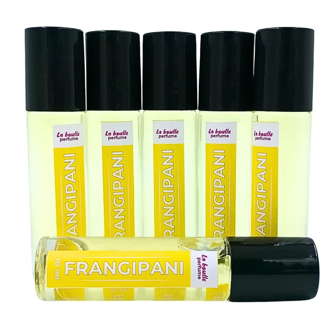 Set of Frangipani perfume roll-on bottles La Boulle with yellow labels and black caps on a white background