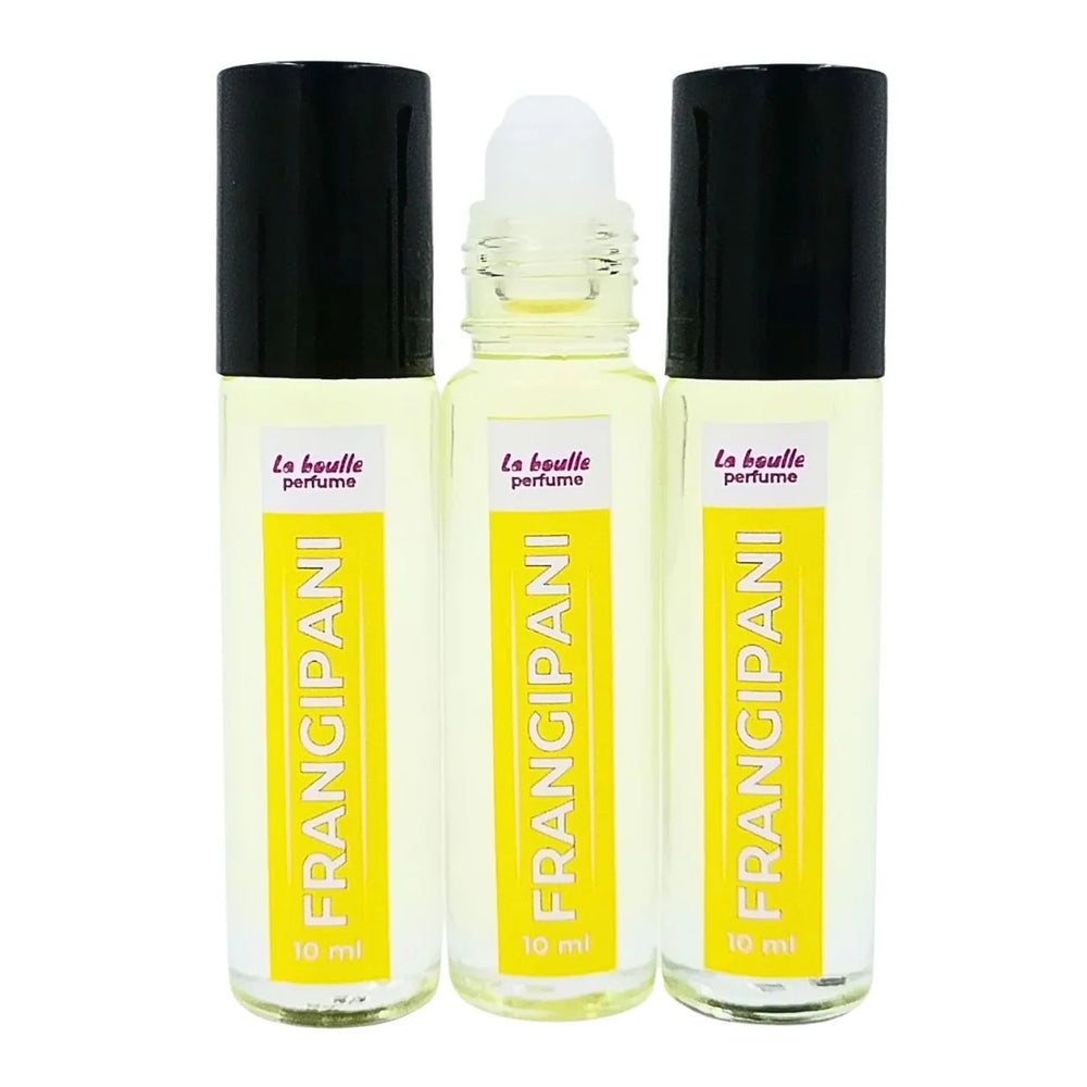 Set of three Frangipani perfume roll-on bottles La Boulle with yellow labels and black caps on a white background