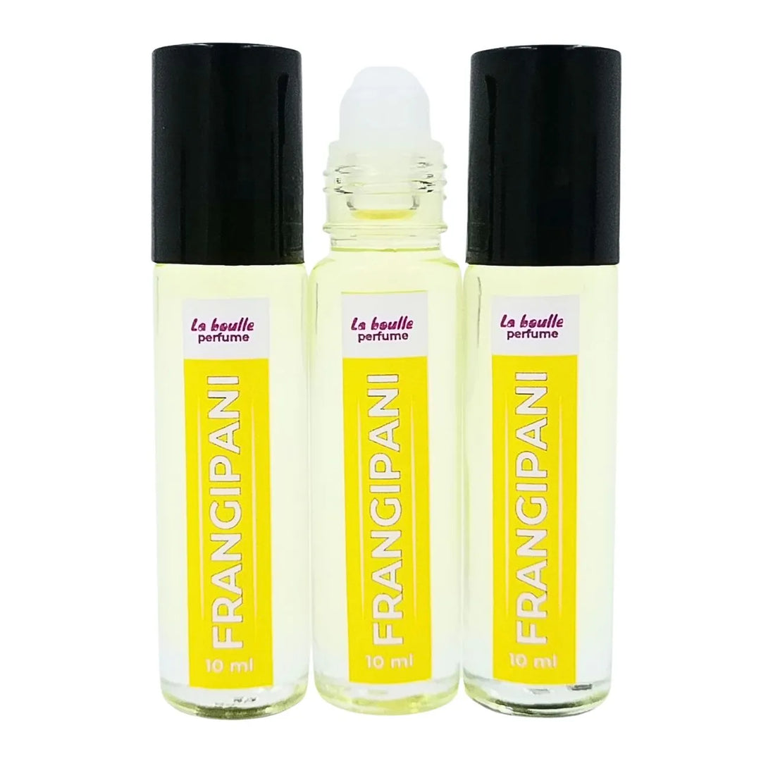 Set of three Frangipani perfume roll-on bottles La Boulle with yellow labels and black caps on a white background
