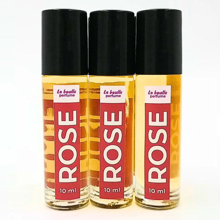 Rose roll-on perfume bottles La Boulle with black caps on a white background