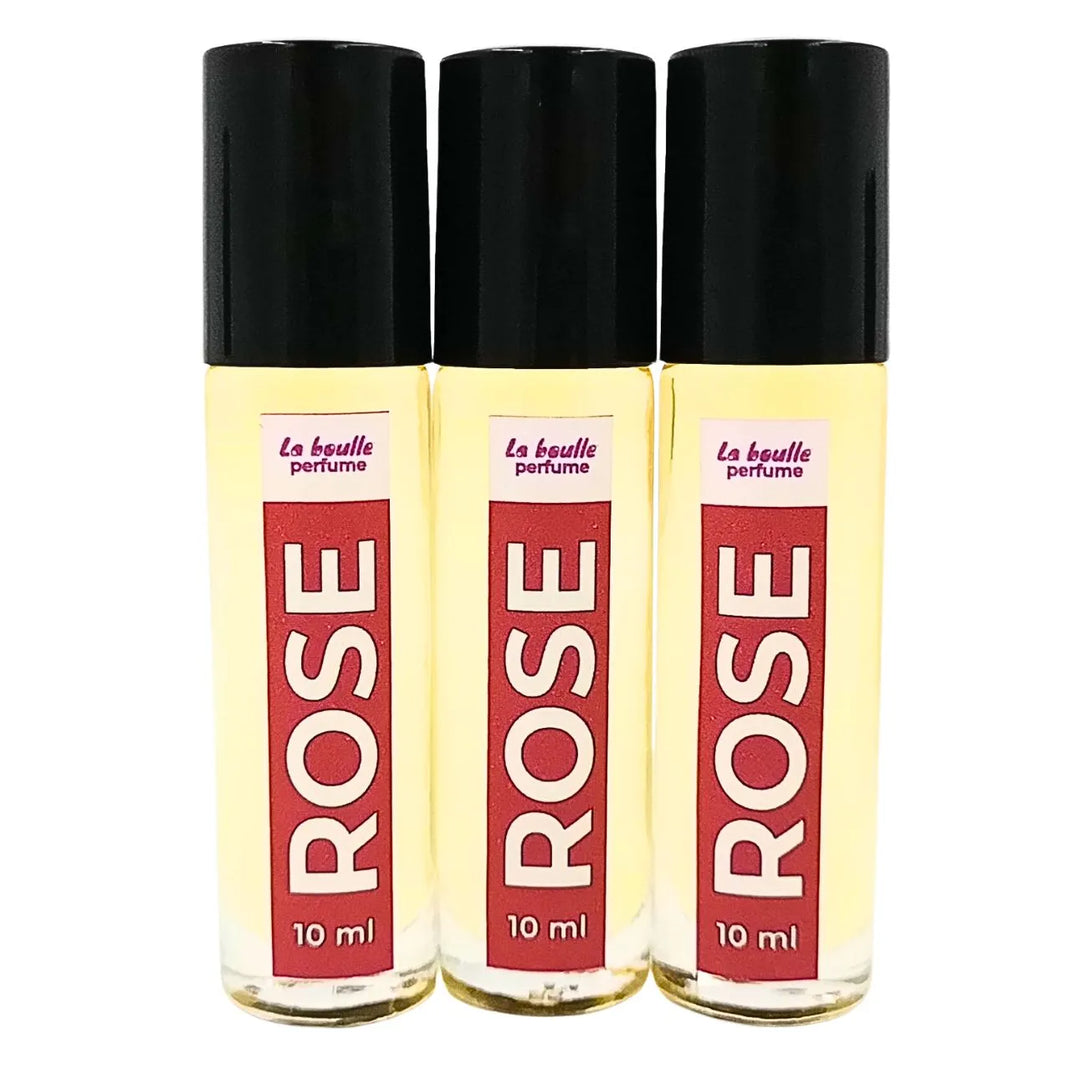 Rose roll-on perfume bottles La Boulle with black caps on a white background