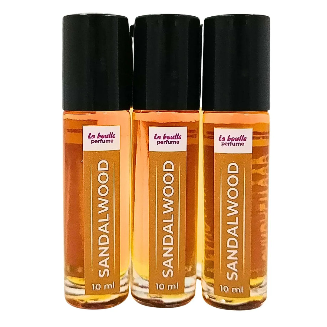 Sandalwood roll-on perfume bottles La Boulle with black caps on a white background