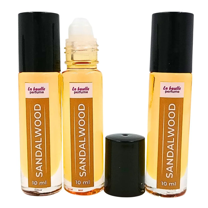 Sandalwood roll-on perfume bottles La Boulle with black caps on a white background