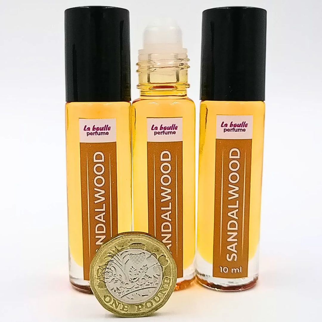 Sandalwood roll-on perfume bottles La Boulle with black caps on a white background