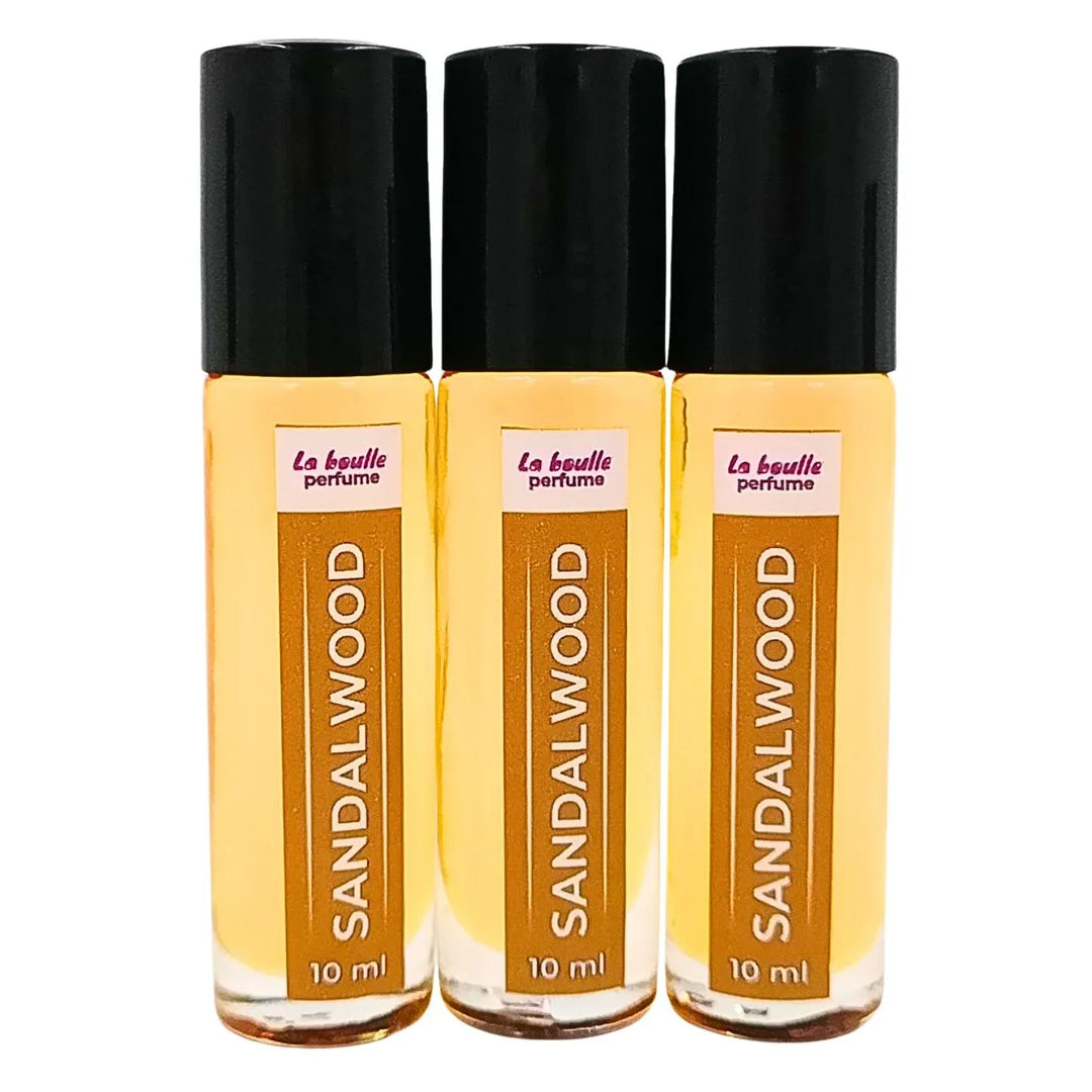 Sandalwood roll-on perfume bottles La Boulle with black caps on a white background