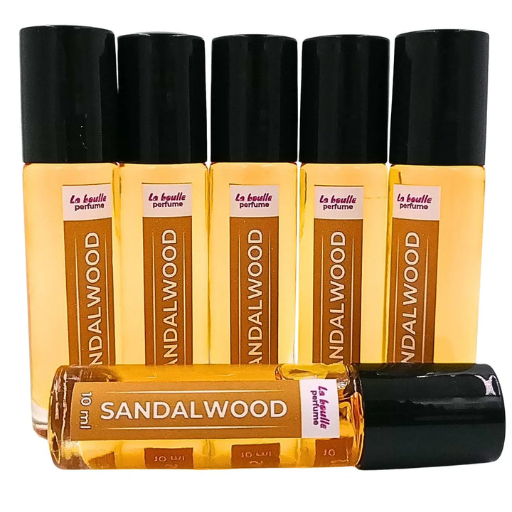 Sandalwood roll-on perfume bottles La Boulle with black caps on a white background
