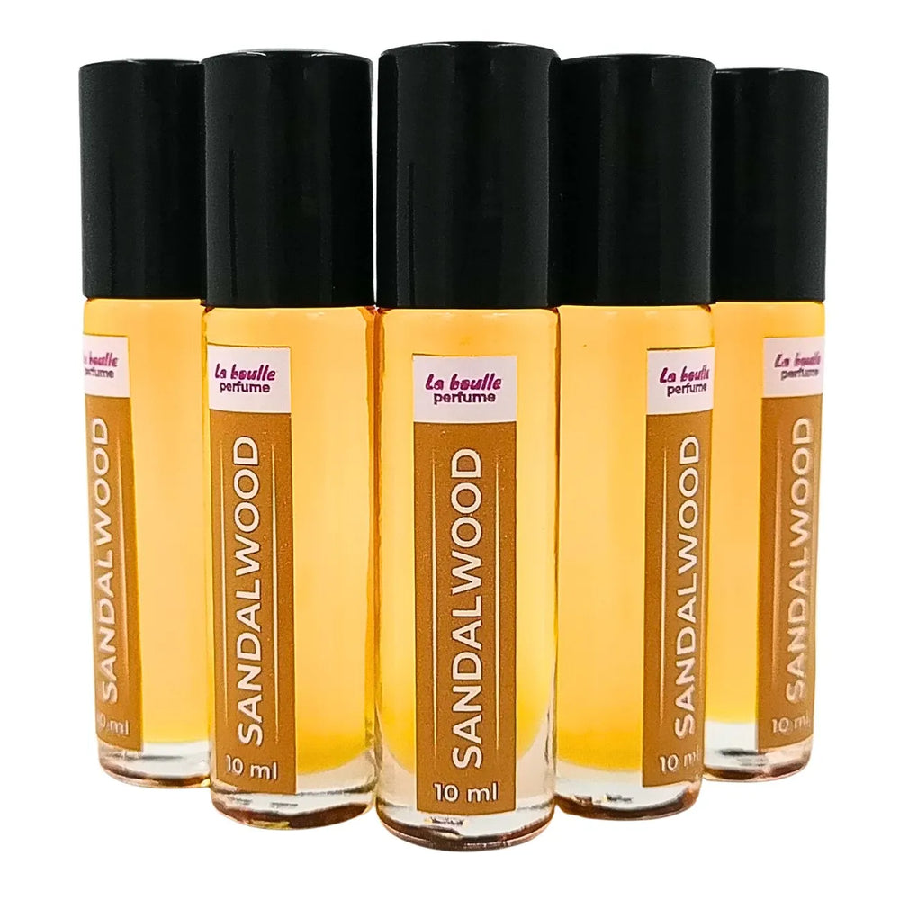 Sandalwood roll-on perfume bottles La Boulle with black caps on a white background